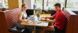 PHSC female and male sitting in the Bobcat Bistro Cafe.