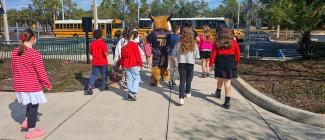 Young children following PHSC's mascot Boomer the Bobcat